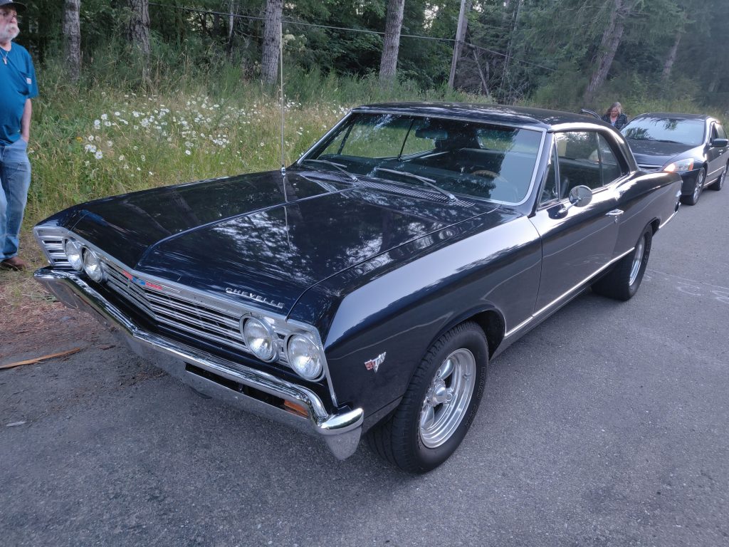 1966 or 67 Chevy Chevelle at a car show. Black in color.