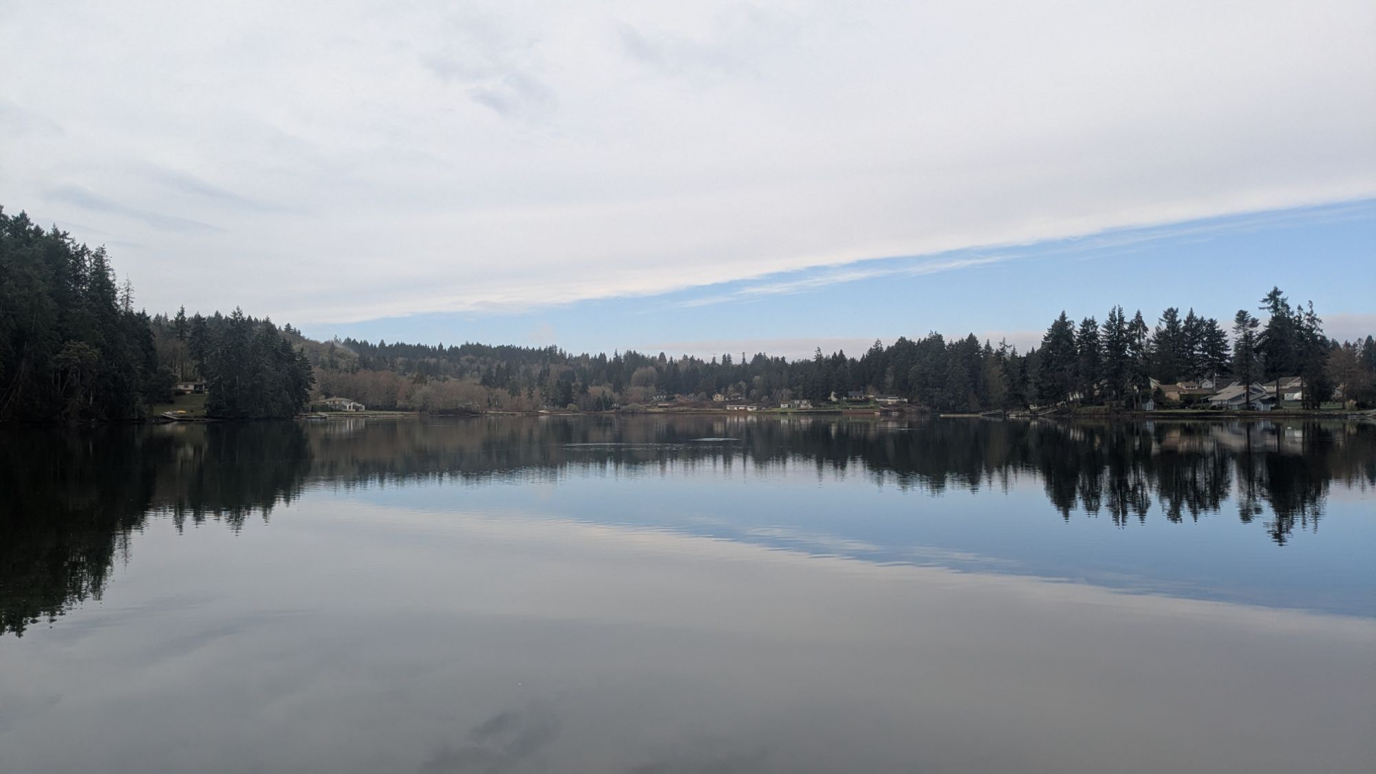 The lakeside reflecting off of the water